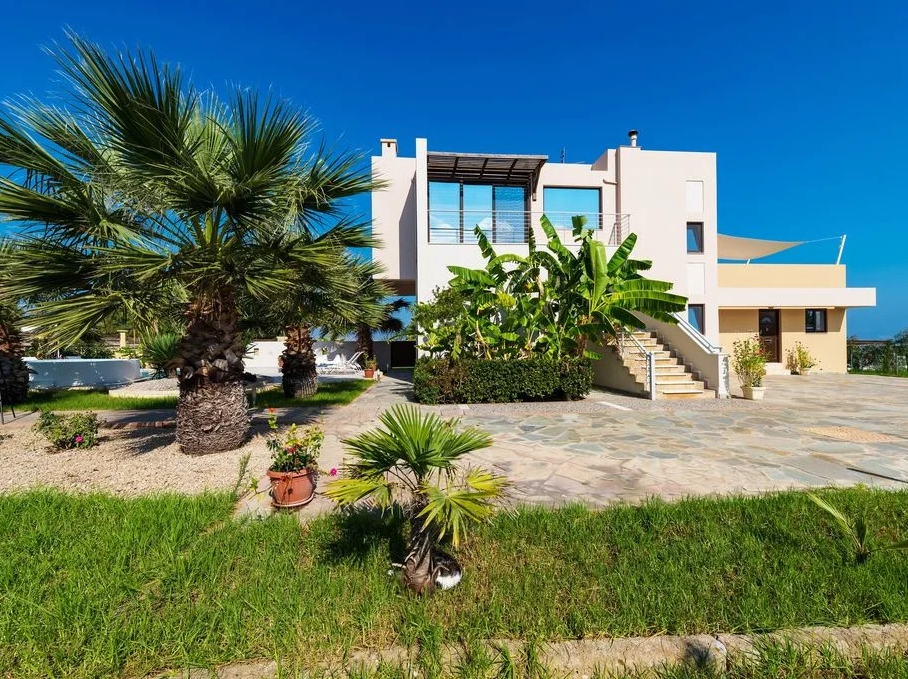 Xenos Villa exterior view with pool and garden